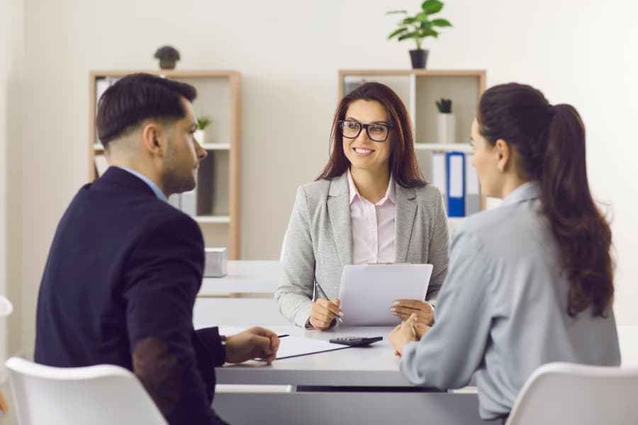 Friendly mortgage broker meeting with young couple