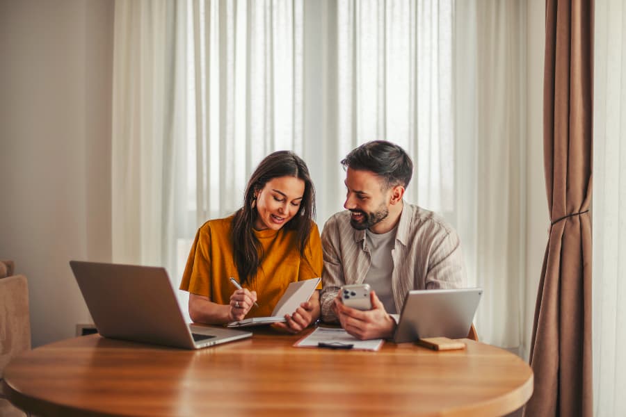 Couple planning finances at dining room table